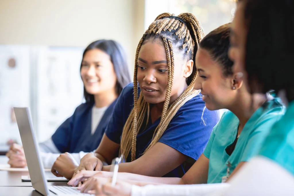 Nursing-students-looking-at-a-computer-screen-in-class